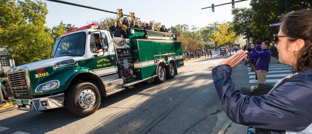 A Simpson Rural Fired Department truck with ECU students riding on it in the homecoming parade